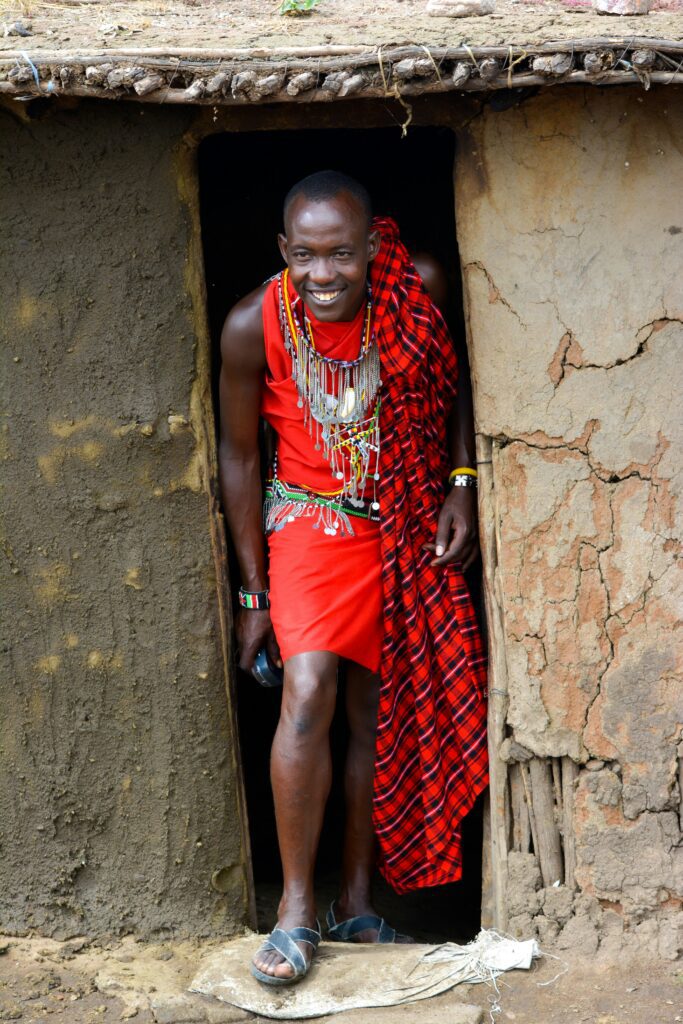 Maasai man leaving his house